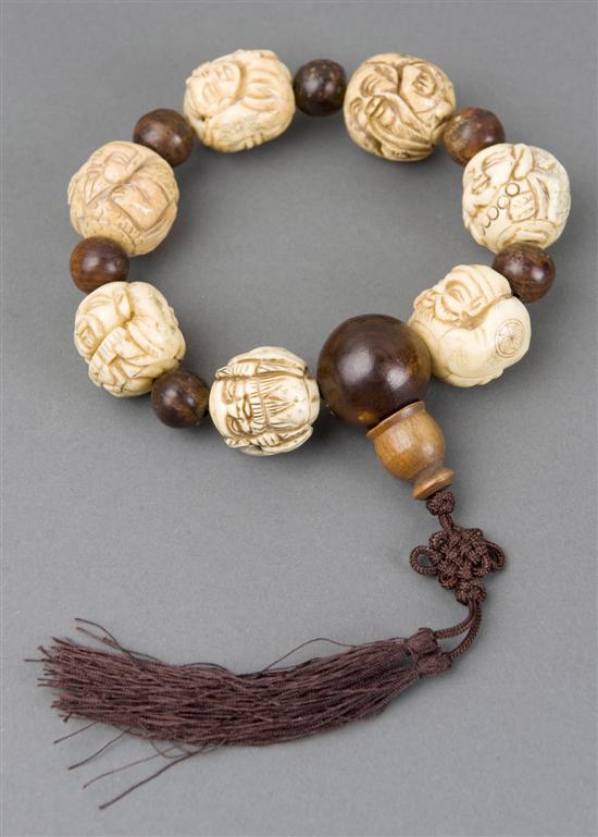 Appraisal: Japanese ivory ojime bracelet Having seven carved ivory ojime beads