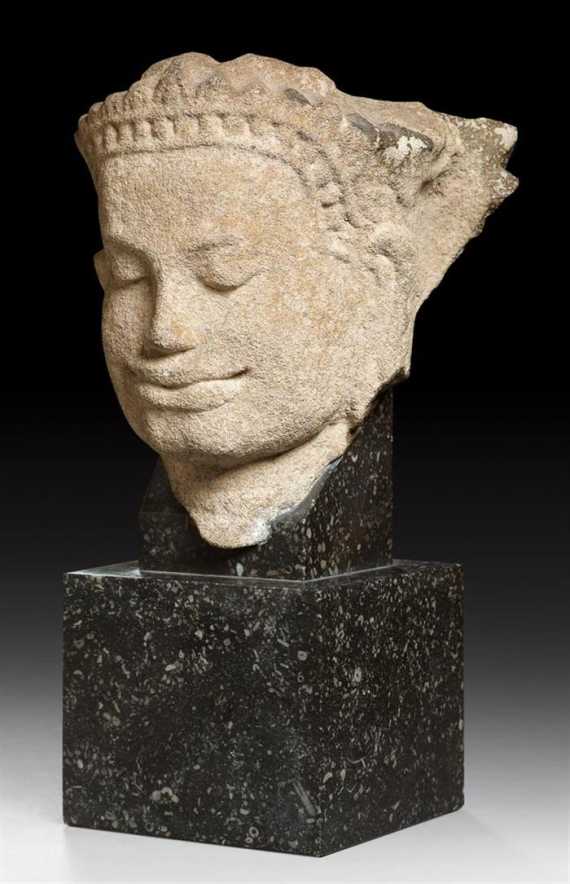 Appraisal: A FINE SANDSTONE HEAD OF A MALE DEITY Khmer Bayon