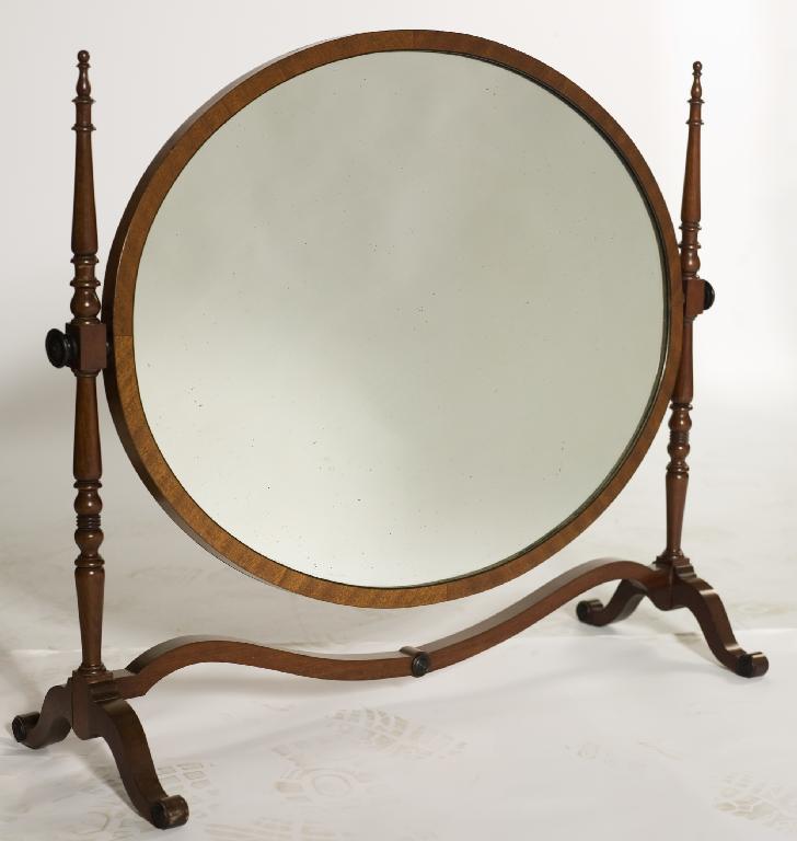 Appraisal: EDWARDIAN MAHOGANY TOILET MIRROR the oval plate swivelling between turned