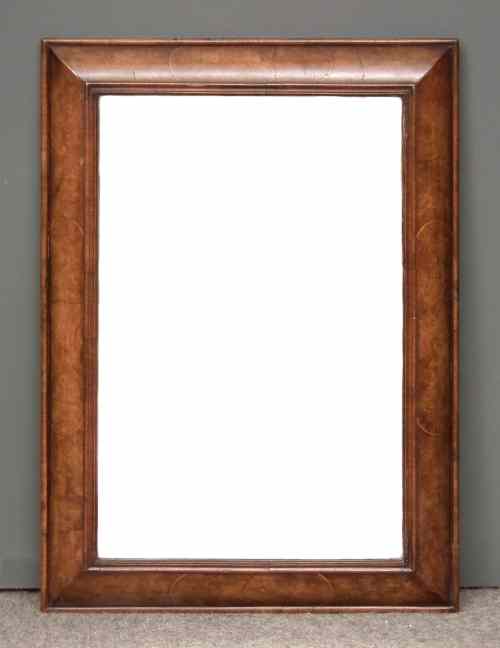 Appraisal: A figured walnut rectangular cushion moulded wall mirror of th