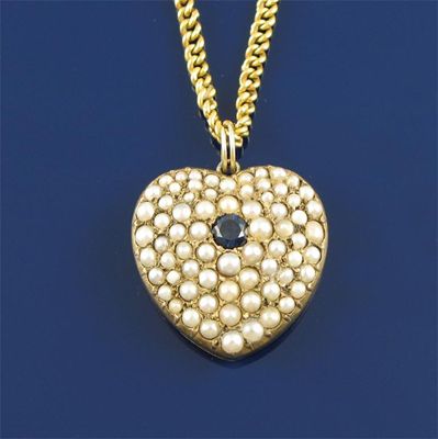 Appraisal: A sapphire and graduated seed pearl set gold heart locket