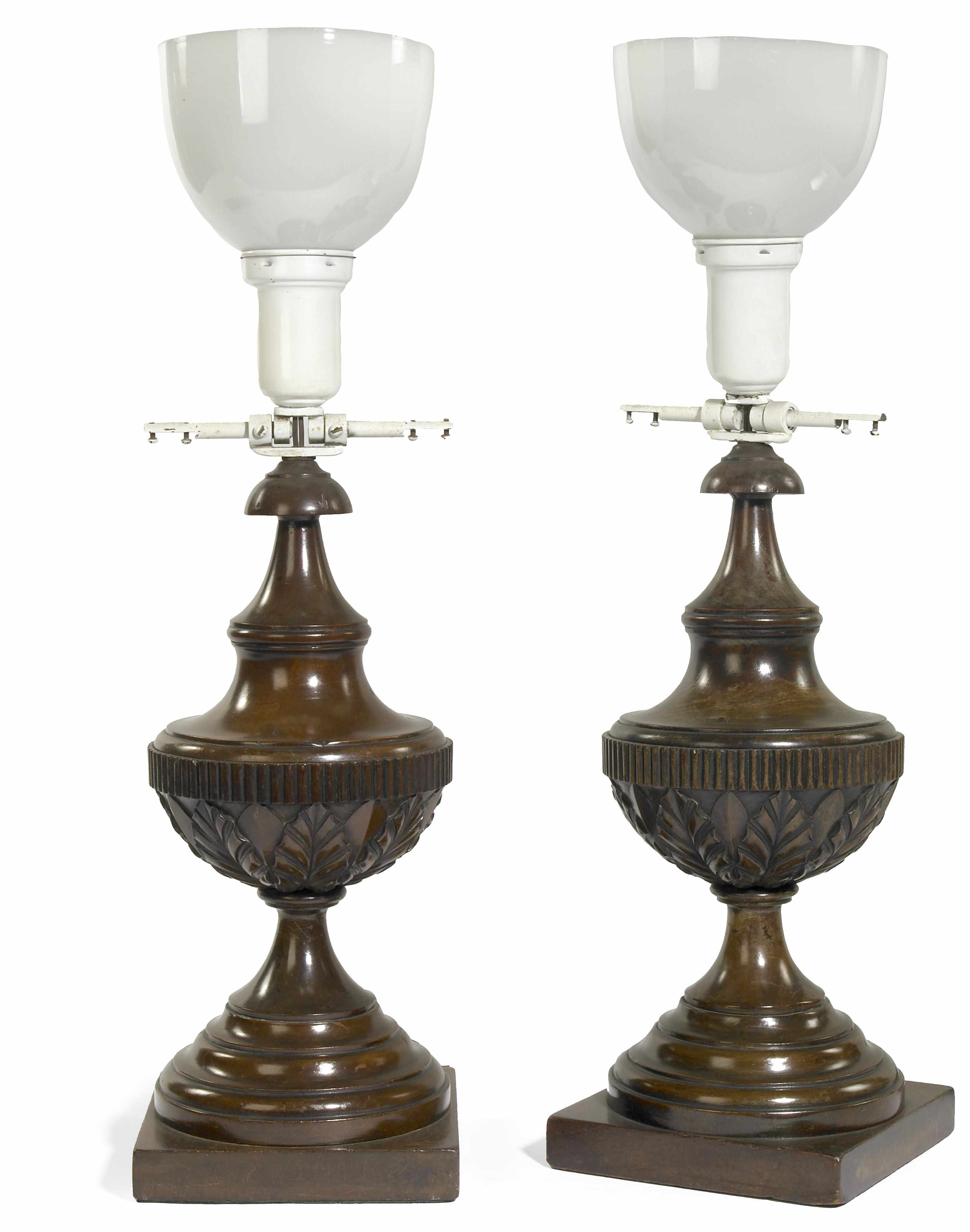 Appraisal: A pair of Neoclassical style carved wood table lamps with