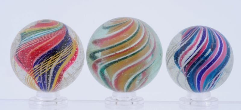 Appraisal: Lot Of Swirl Marbles Lot includes two multicolor solid core