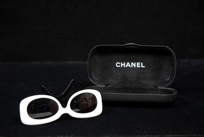 Appraisal: Chanel sunglasses White squared-off cat-eye frames with black arms and