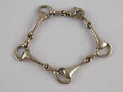 Appraisal: A silver bracelet designed as interlocking stirrups approx cm long