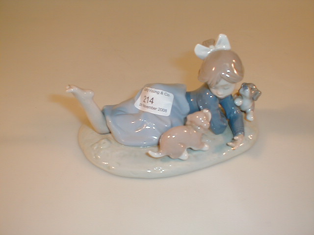 Appraisal: A Lladro figurine of reclining girl with two puppies