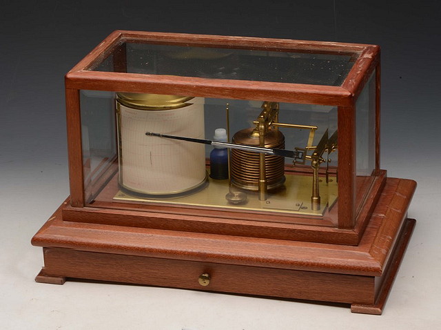 Appraisal: A MAHOGANY CASED BAROGRAPH the drawer containing spare charts