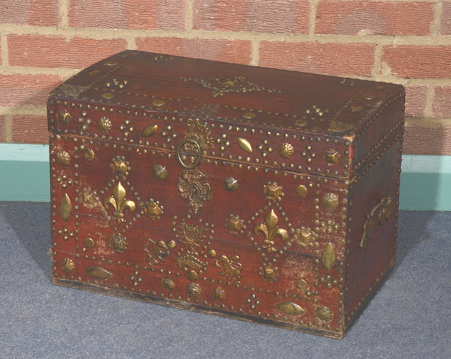 Appraisal: A SPANISH RED LEATHER COVERED CHEST with brass studded decoration