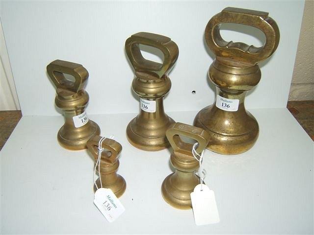 Appraisal: AN ASSOCIATED PART SET OF FIVE BRASS BELL WEIGHTS lb