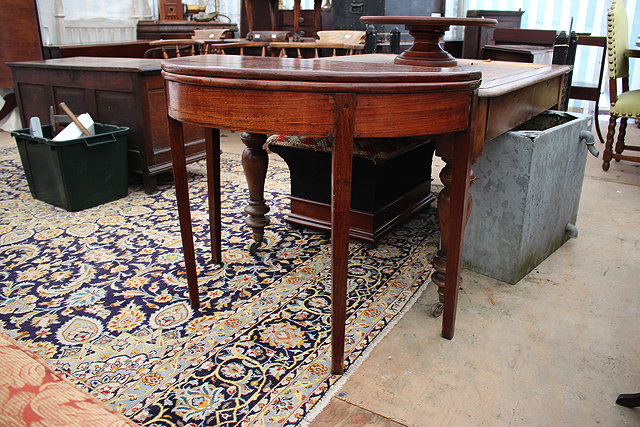 Appraisal: A TH CENTURY MAHOGANY DEMI-LUNE FOLD OVER TEA TABLE standing