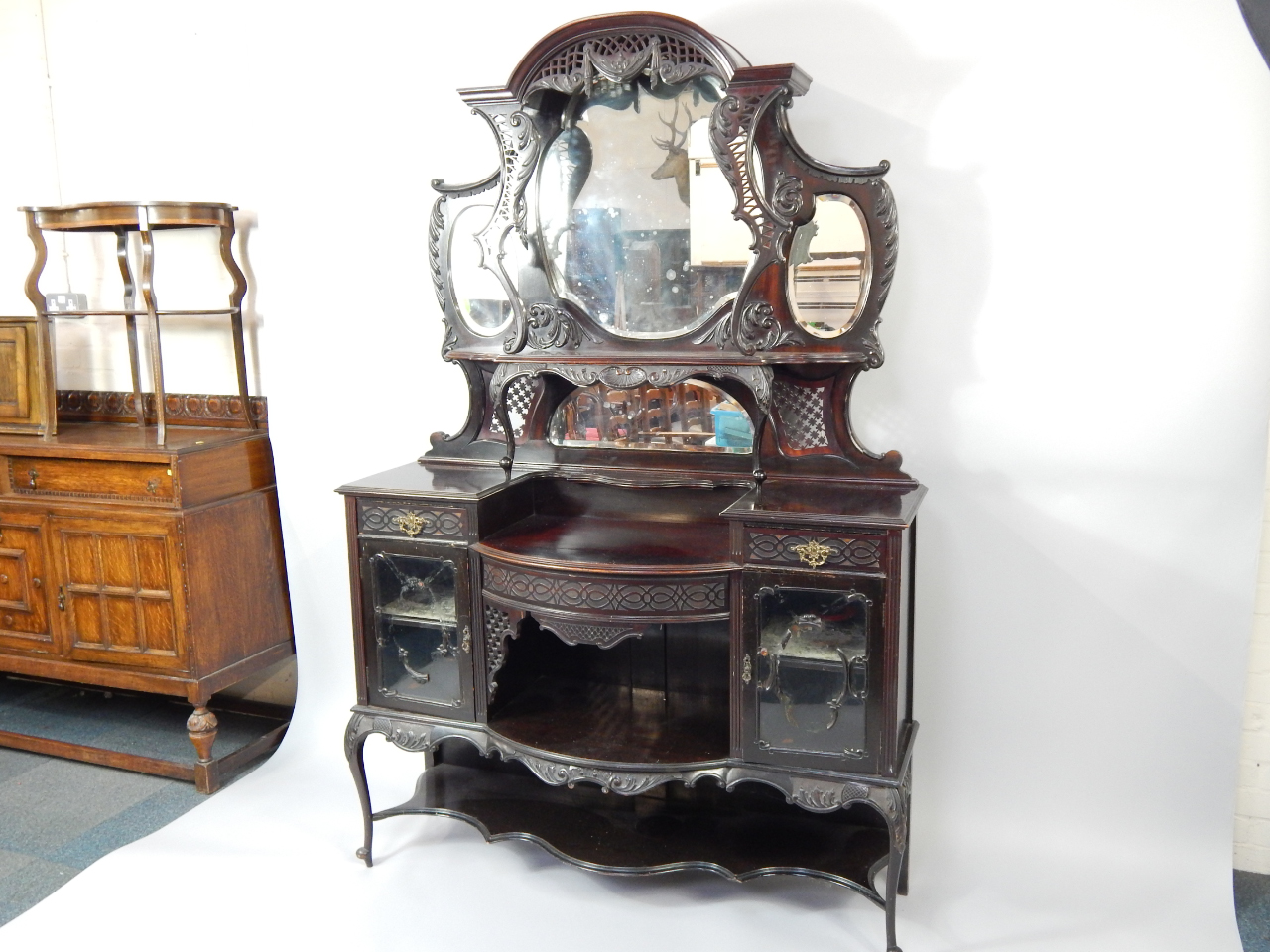 Appraisal: A Victorian mahogany display cabinet the domed pediment over a