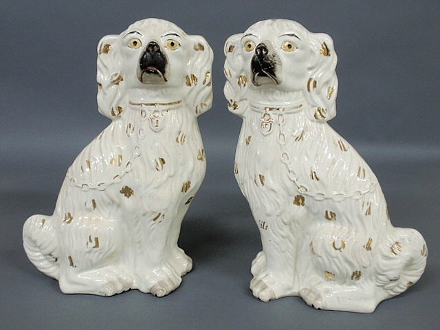 Appraisal: Large pair of Staffordshire white seated Spaniels with yellow eyes