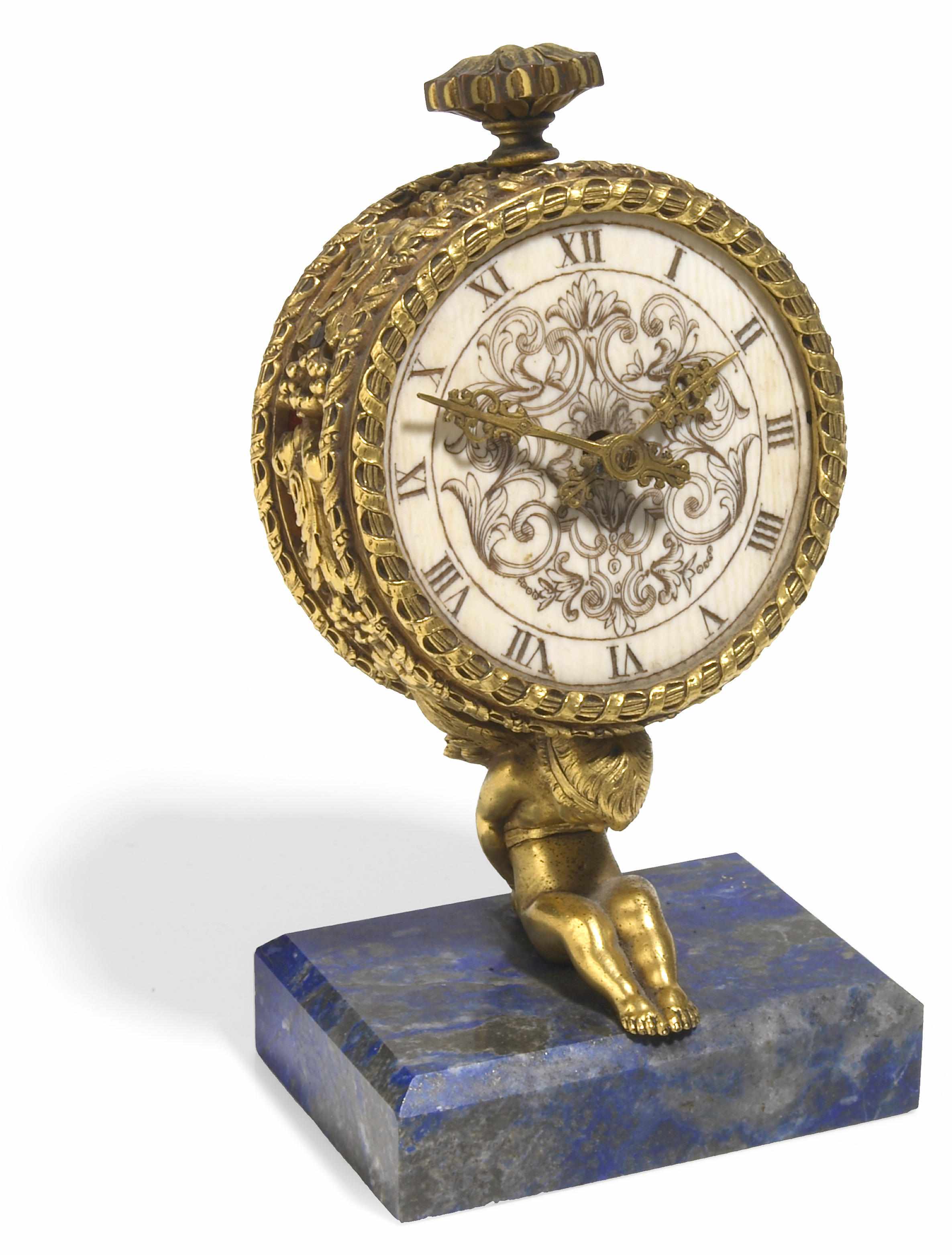 Appraisal: A gilt bronze ivory and lapis lazuli desk timepiece probably