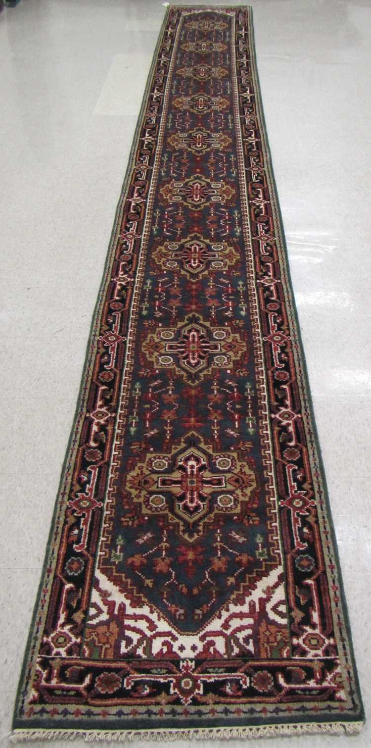 Appraisal: HAND KNOTTED ORIENTAL RUNNER Persian Serapi design of nine geometric