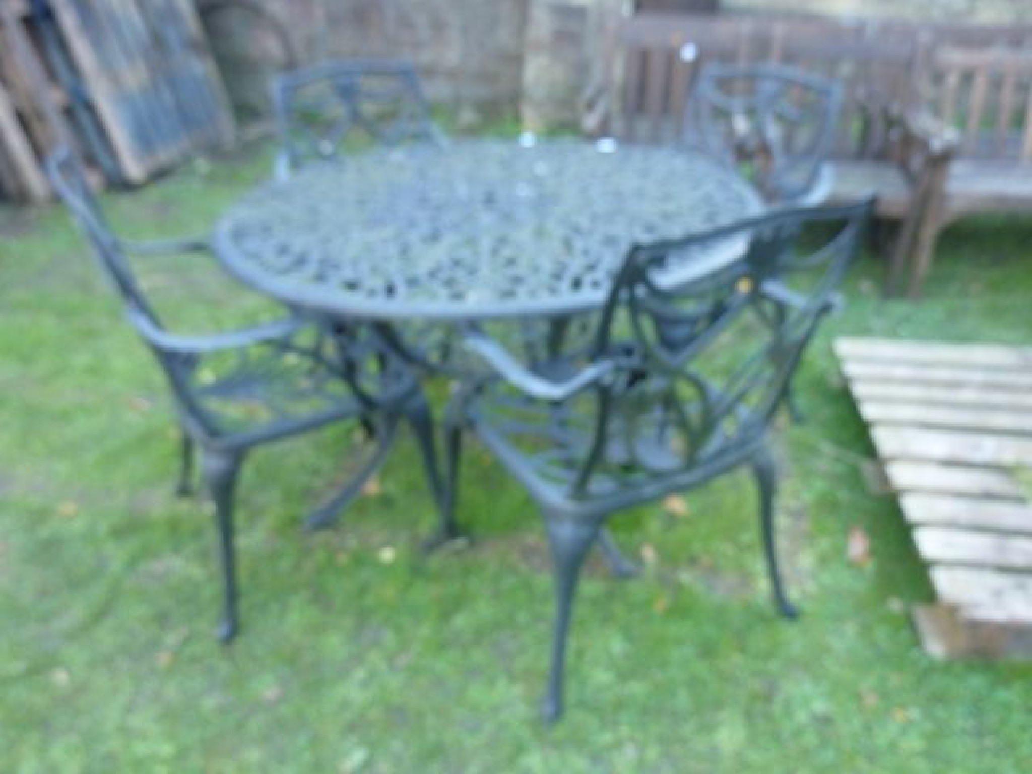 Appraisal: A contemporary cast aluminium garden terrace set comprising table of