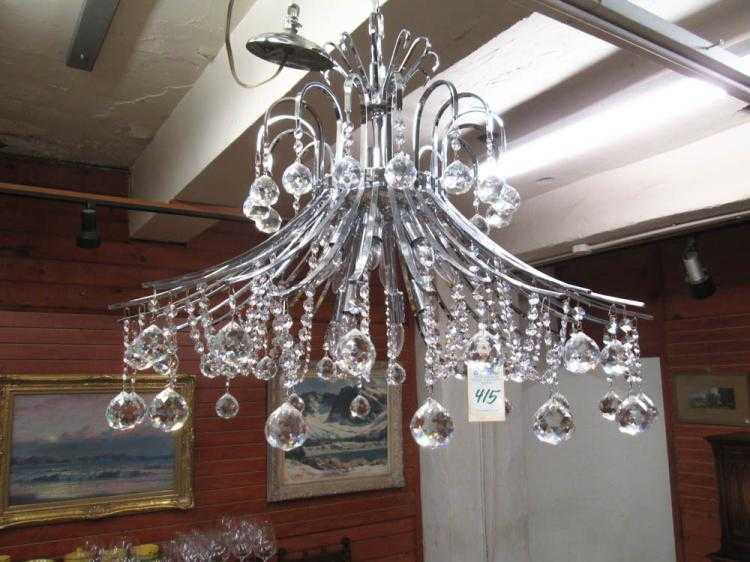 Appraisal: A CONTEMPORARY CRYSTAL AND CHROMED METAL CHANDELIER having downward swept