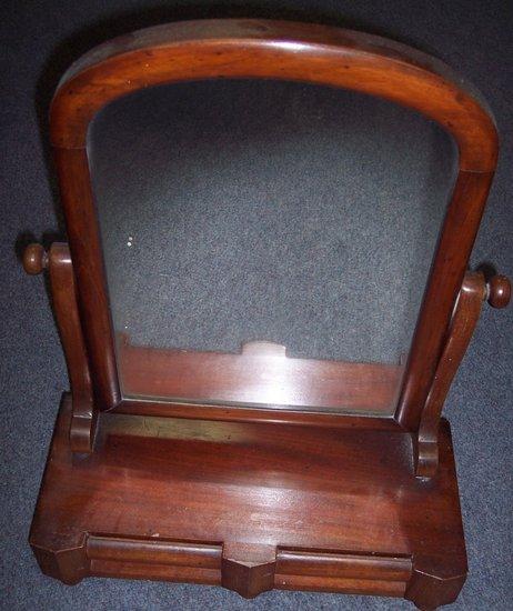 Appraisal: A Victorian mahogany swing frame toilet mirror fitted two drawers