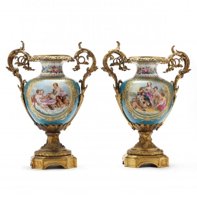 Appraisal: PAIR OF SEVRES STYLE PORCELAIN AND ORMOLU MANTEL URNS Late