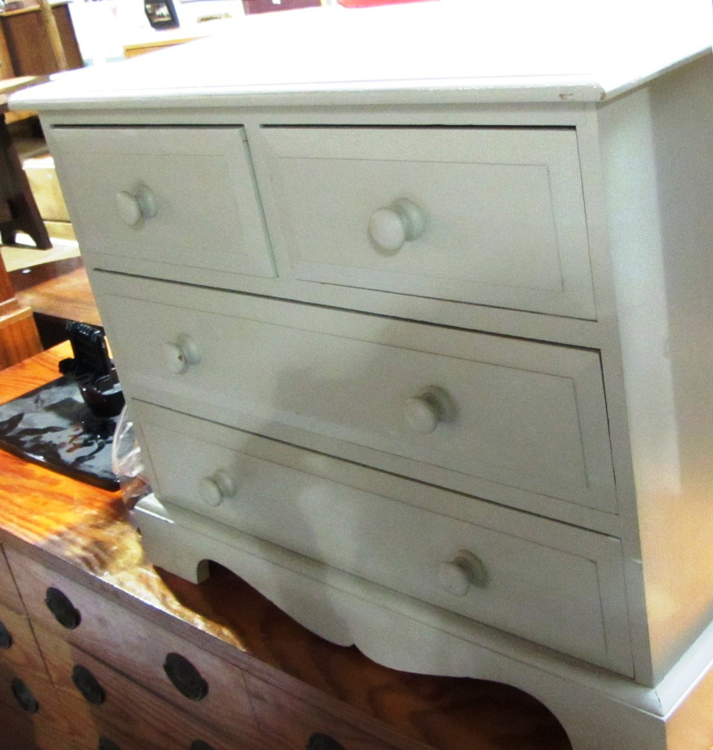 Appraisal: A small cream painted chest of two short and two