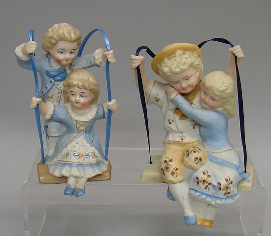 Appraisal: Bisque Swing figurines boy and girl on each Pair of