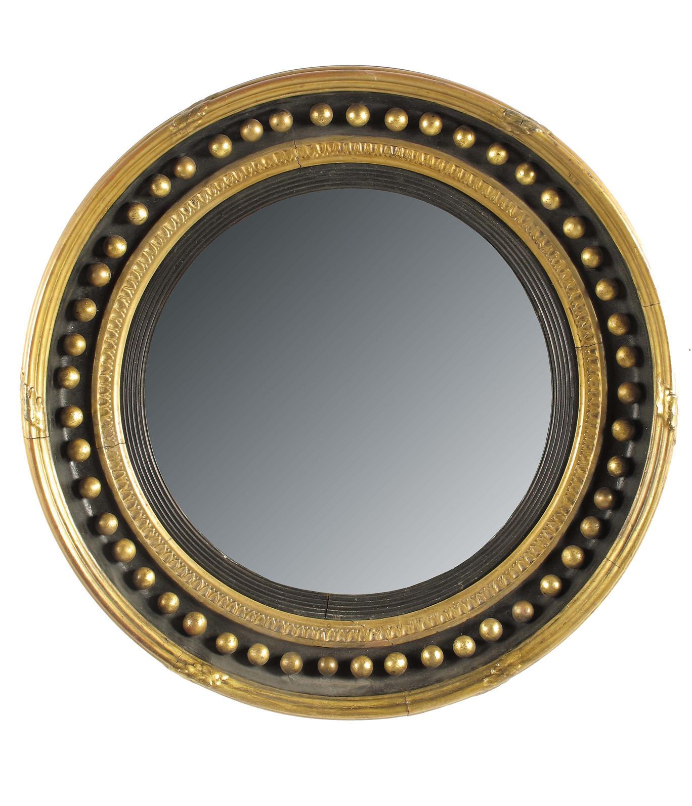 Appraisal: An early th century giltwood and gesso convex wall mirror