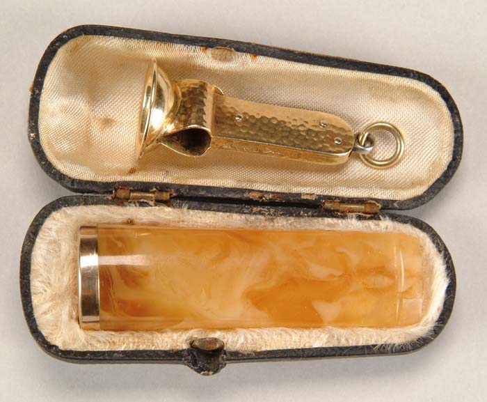 Appraisal: K YELLOW GOLD CIGAR TRIMMER AND GOLD EDGED AMBER CIGAR