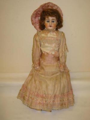 Appraisal: A bisque shoulder head doll with blue sleeping eyes open