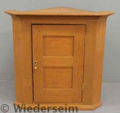 Appraisal: Pine hanging cupboard c with a molded cornice blind door