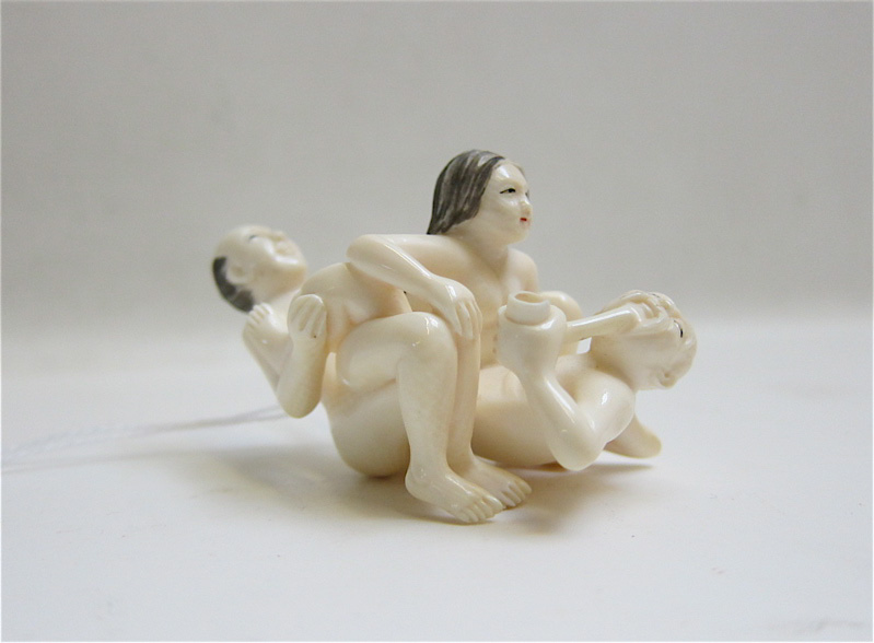 Appraisal: EROTIC CARVED IVORY FIGURAL GROUPING with scrimshaw treatment Height inches