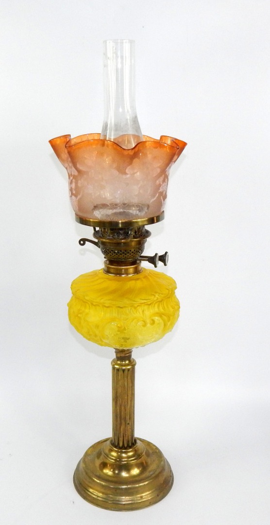 Appraisal: A brass oil lamp with a yellow moulded and etched