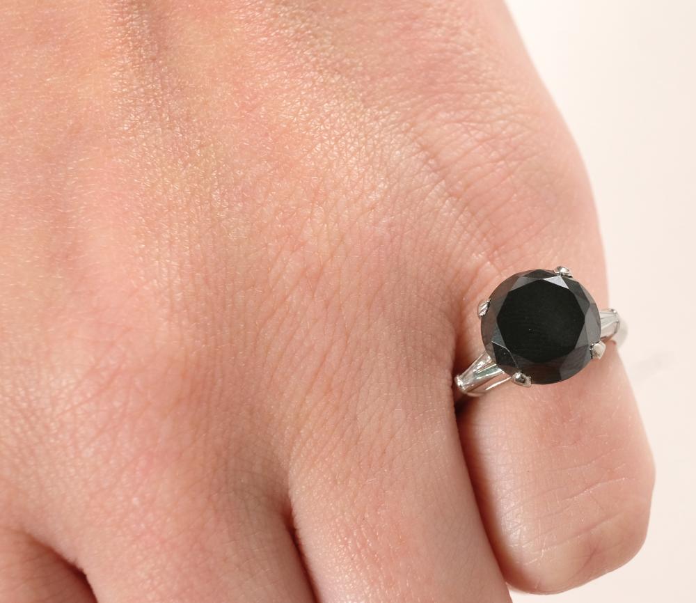 Appraisal: Platinum ring having round cut black center diamond flanked to