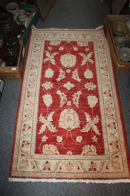 Appraisal: A MORRIS STYLE RED GROUND RUG cm x cm and