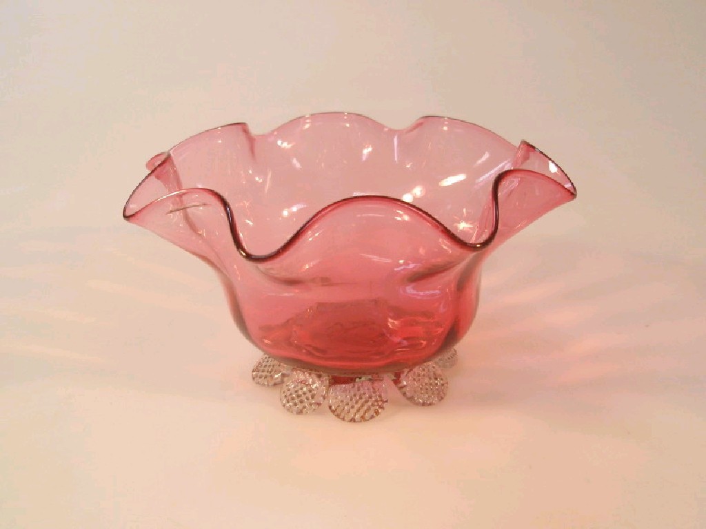 Appraisal: A thC cranberry glass bowl with fluted rim and clear