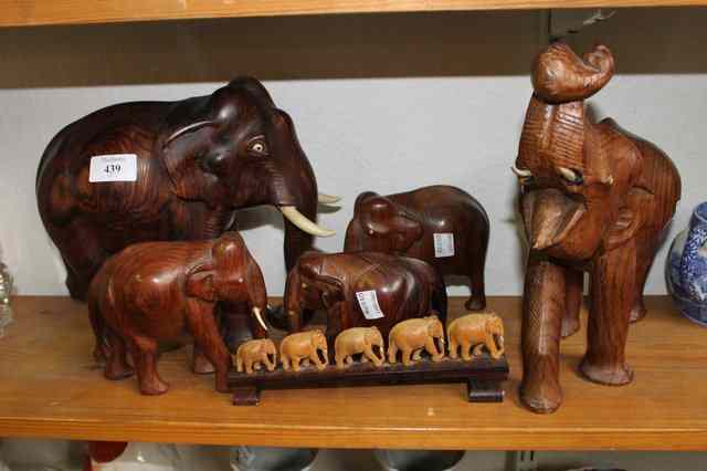 Appraisal: A TROOP OF CARVED HARDWOOD ELEPHANTS together with a smaller