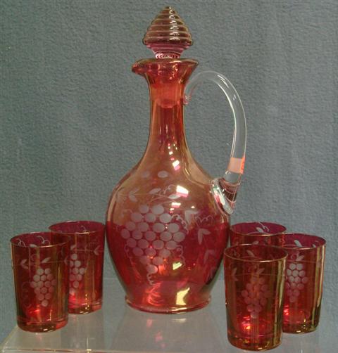 Appraisal: pc etched ruby flashed Bohemian liquer set decanter clear handle