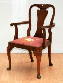 Appraisal: A George I style walnut and upholsterred armchair