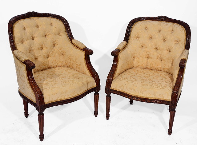 Appraisal: A PAIR OF FRENCH BEECHWOOD ARMCHAIRS with carved decoration and