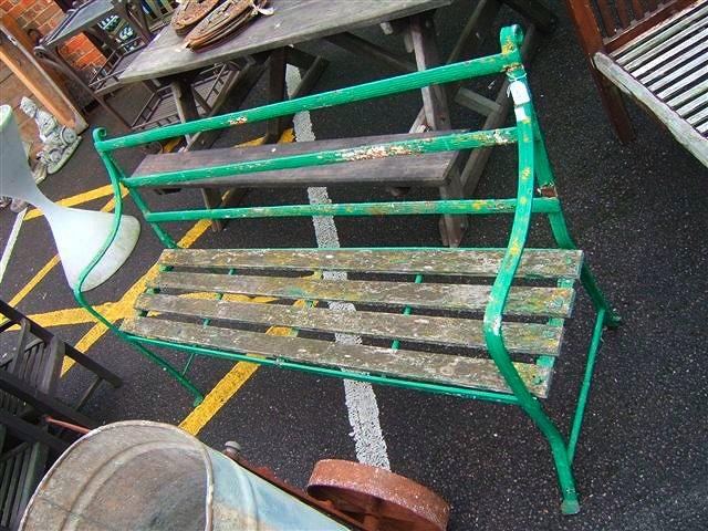 Appraisal: A green painted th Century wrought iron garden seat with