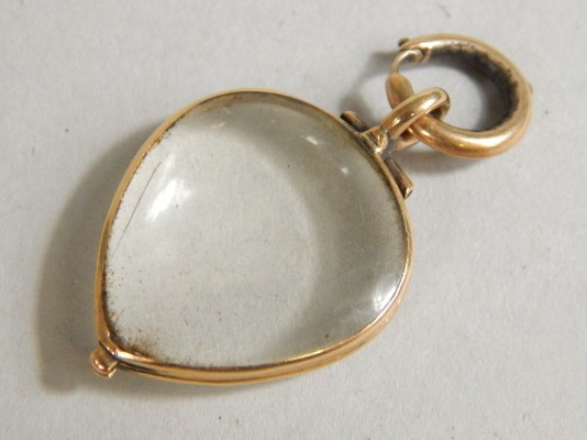 Appraisal: A heart shaped pendant centred by a glass section for