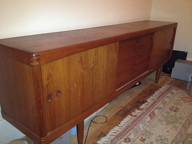 Appraisal: A SCANDINAVIAN 'S TEAK SIDEBOARD with four central short drawers