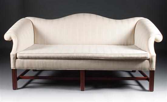 Appraisal: Chippendale style carved mahogany upholstered camelback sofa in H in