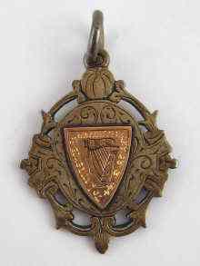 Appraisal: An Irish silver fob with applied gold shield Dublin