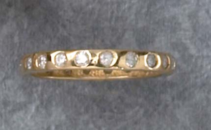 Appraisal: DIAMOND ETERNITY RING k yellow gold ring set with twenty