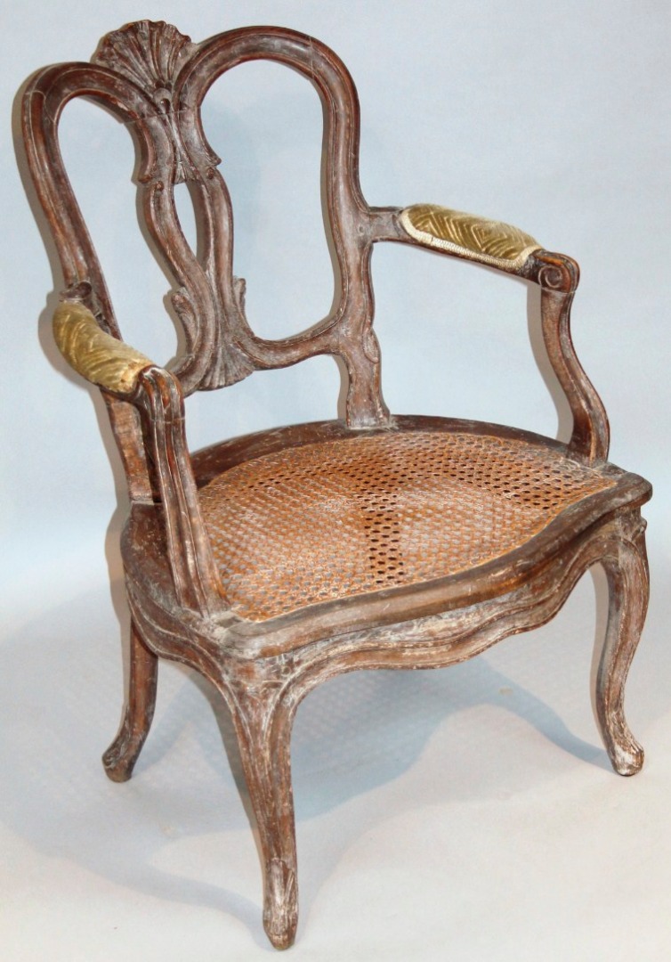 Appraisal: A rococo design elbow chair with a deep serpentine bergere