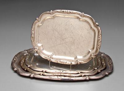 Appraisal: Four silver-plate trays rounded rectangular forms with scroll and foliate