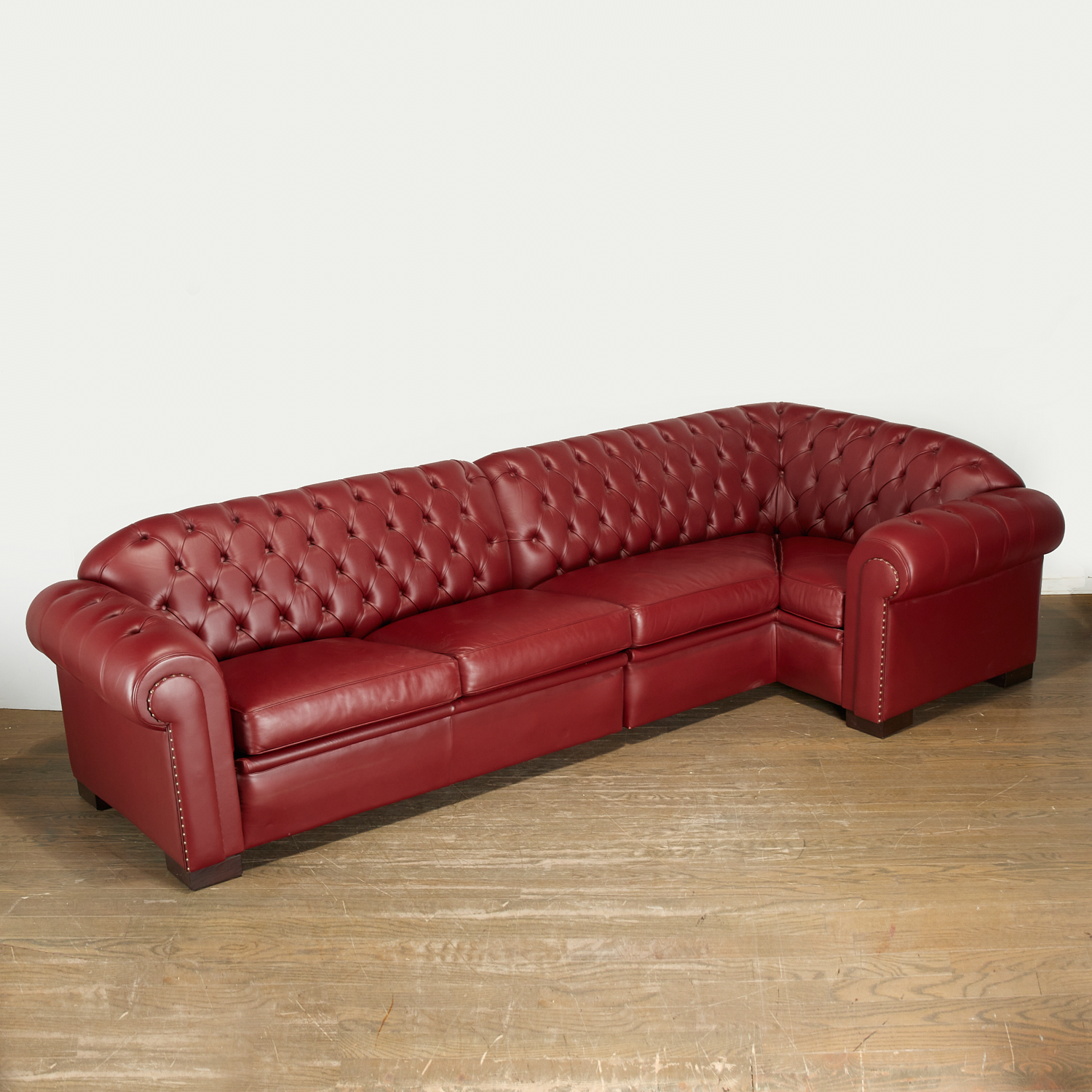 Appraisal: JUAN PABLO MOLYNEUX CUSTOM TUFTED SECTIONAL SOFA th c burgandy