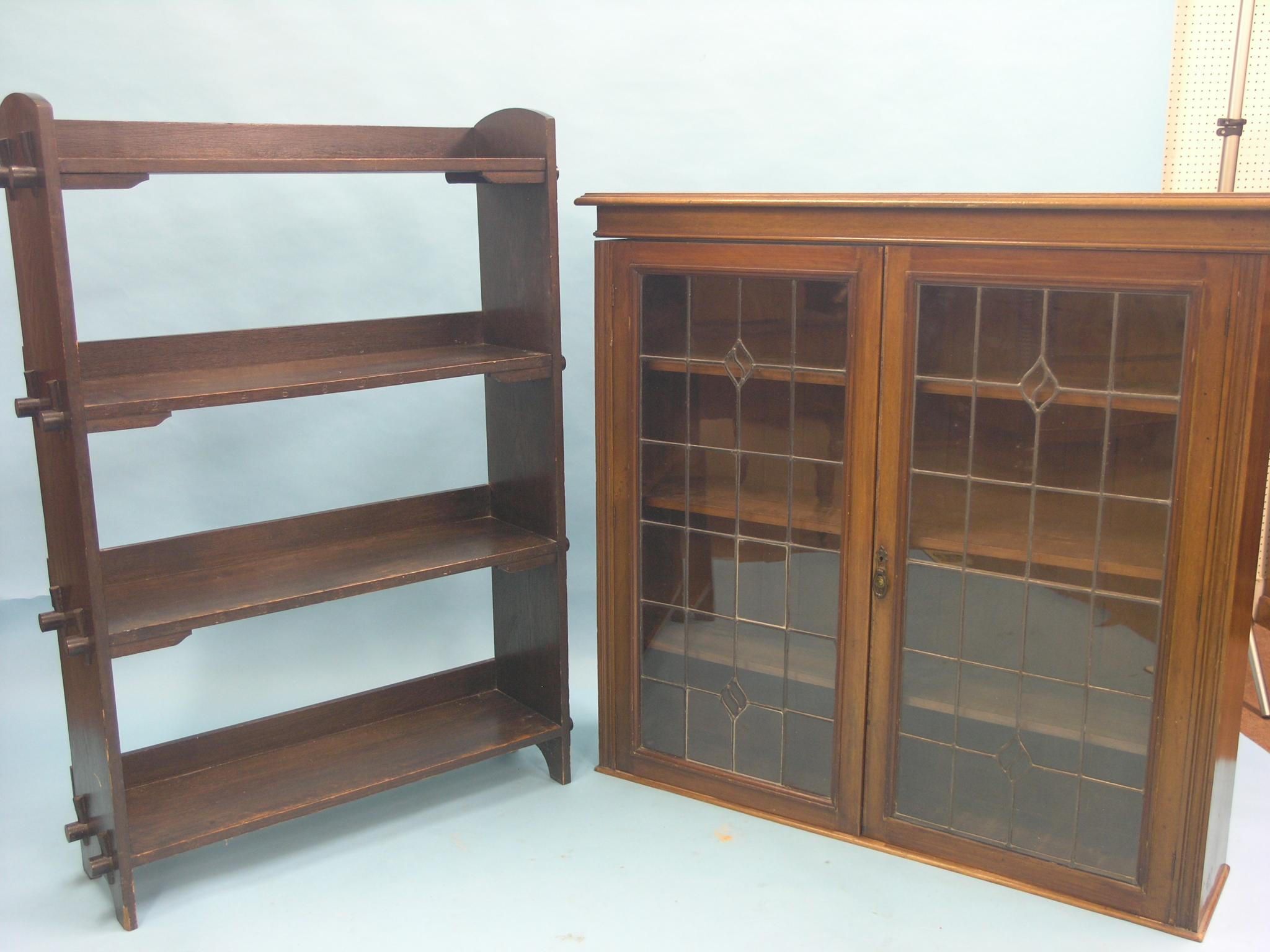 Appraisal: An early th century walnut bookcase enclosed by a pair