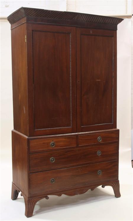 Appraisal: A George IV mahogany linen press the carved projected cornice