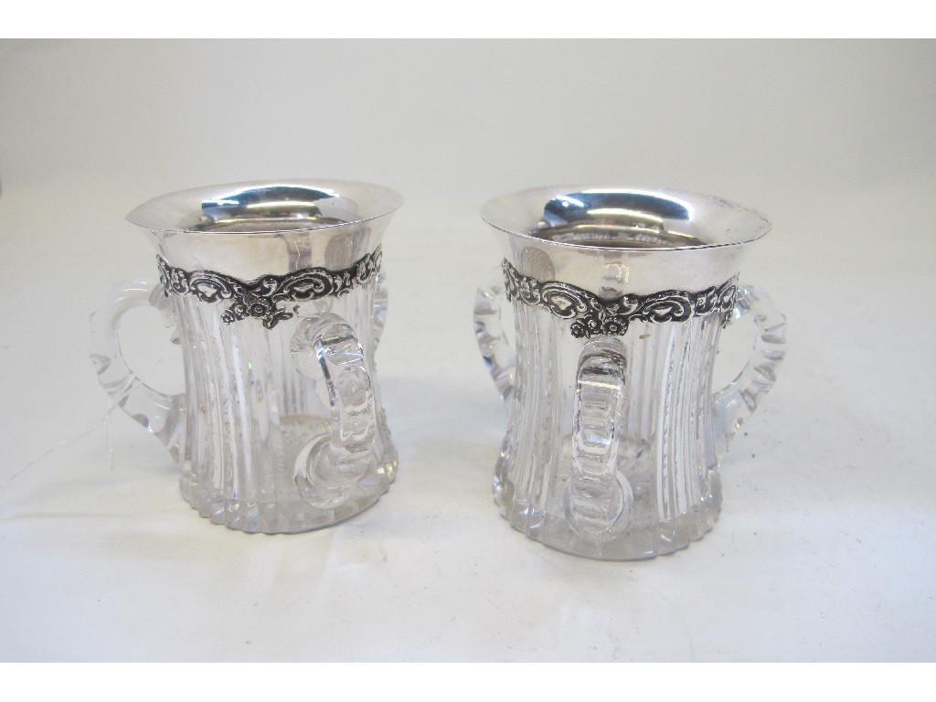 Appraisal: A pair of American sterling silver mounted three handled cut