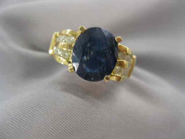 Appraisal: Sapphire Diamond Ring carat deep bluesapphire surrounded by diamonds totaling